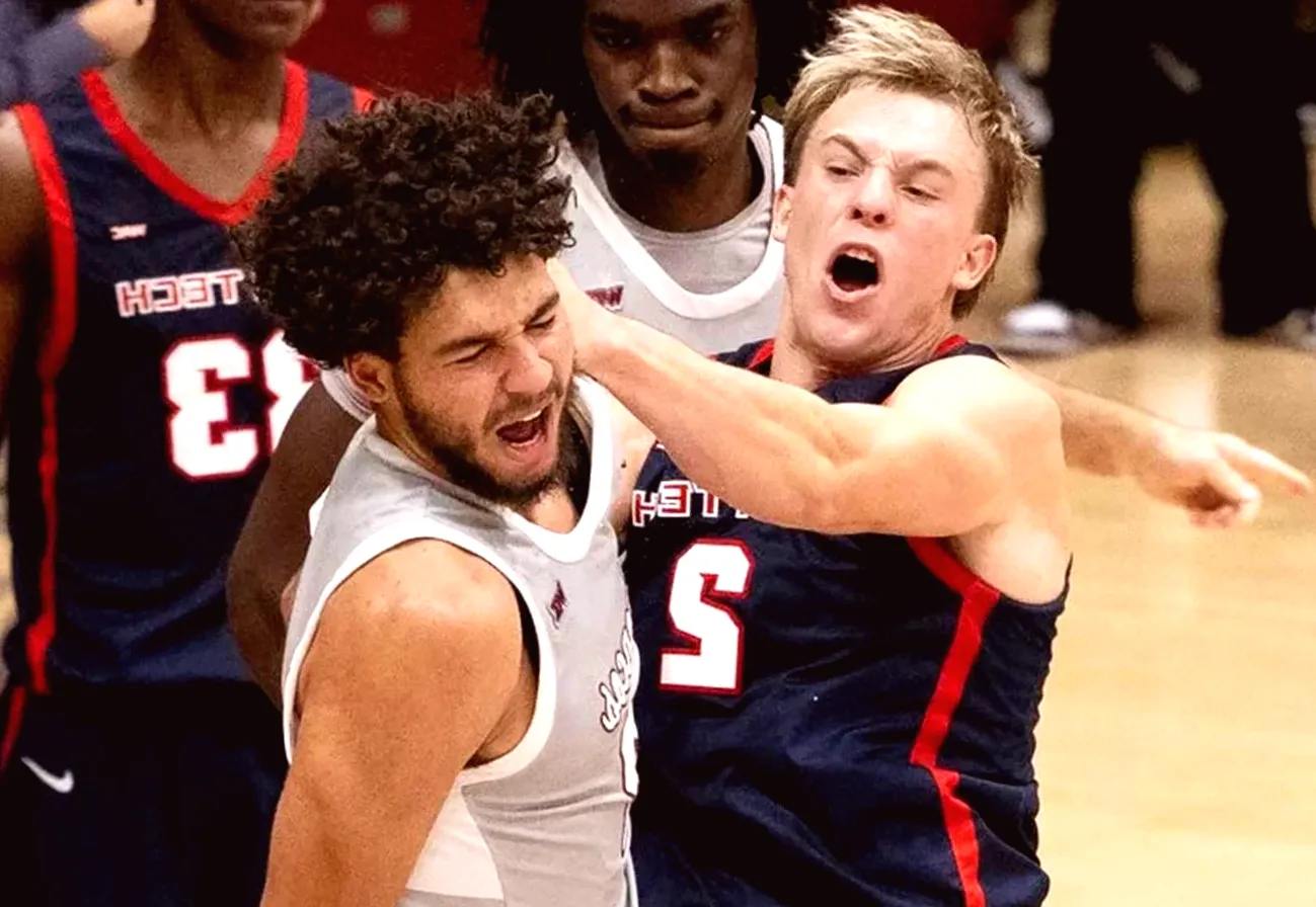 College Basketball Player Throws Punch at Opponent Following Dunk in Chaotic Encounter