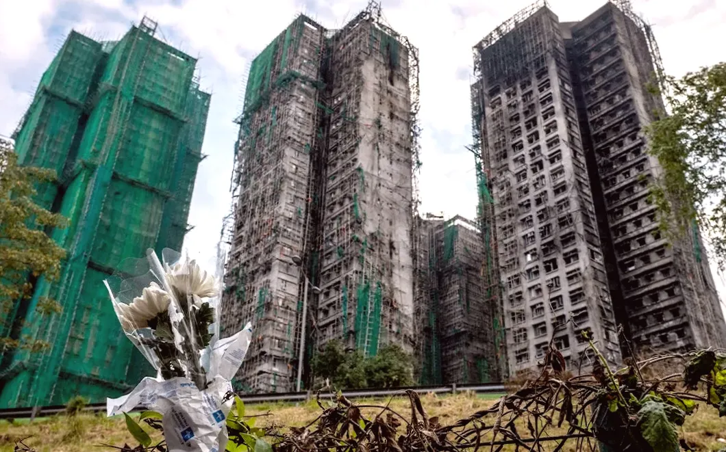 Hong Kong leader emphasizes the importance of discovering the truth following fatal apartment fire, urges building reform.